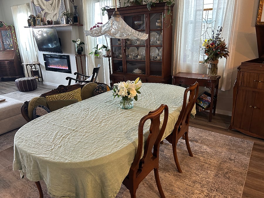 Dining table comfortably seats six under Italian glass light.