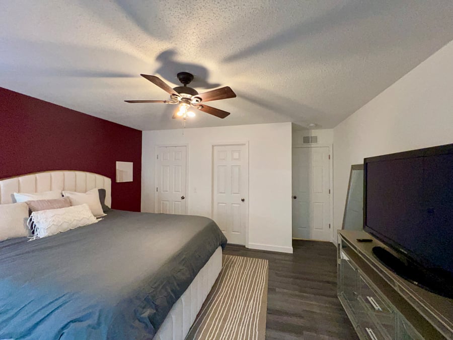 Primary bedroom with walk in closet and bathroom with shower/tub combo