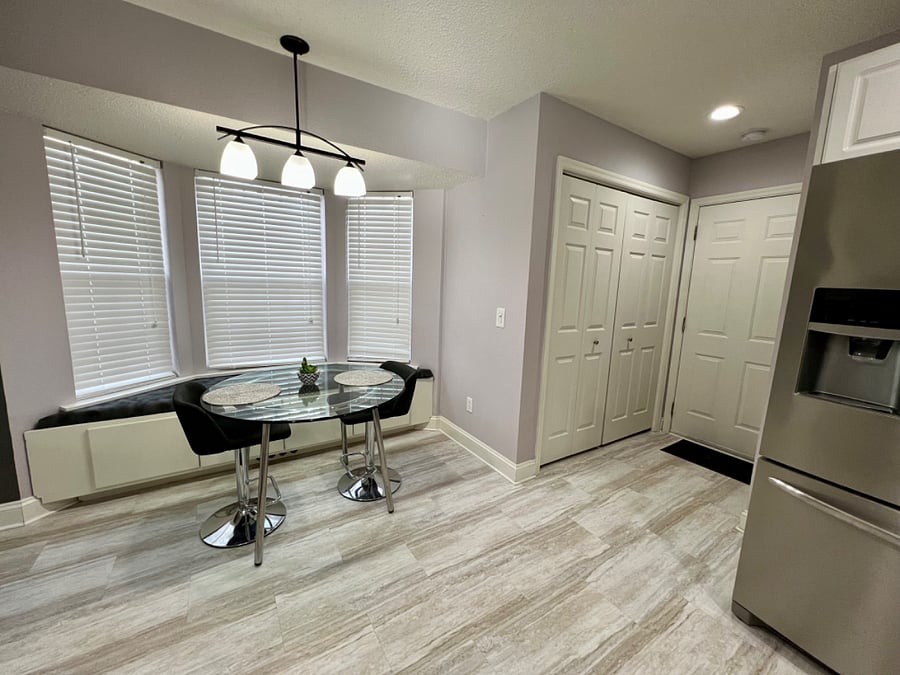 Eating area of the kitchen and laundry behind the doors on the right