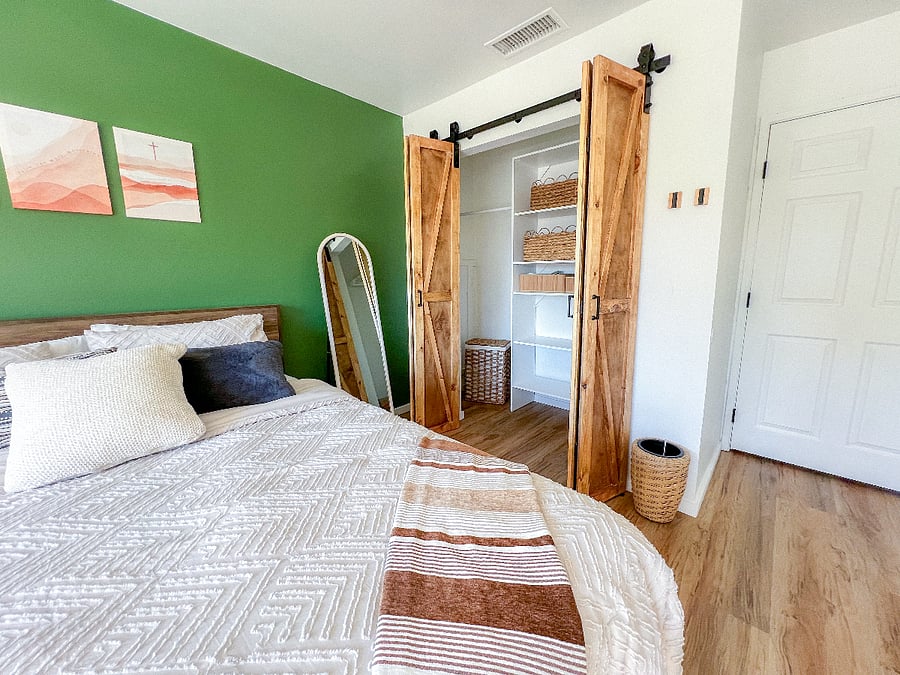 Bedroom 2 with barn doors open:
Inside the closet is a shelving system with a few hangers and baskets for easy organizing, bath towels, house slippers and a laundry basket for your convenience. To the right of the closet door are mounted hooks for your towel, bag or keys. The hooks easily fold up when not in use.