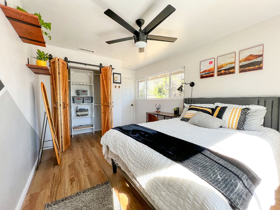Bedroom 1 with barn doors open:
Inside the closet is a shelving system with a few hangers and baskets for easy organizing, bath towels, house slippers and a laundry basket for your convenience. To the right of the closet door are mounted hooks for your towel, bag or keys. The hooks  easily fold up when not in use.