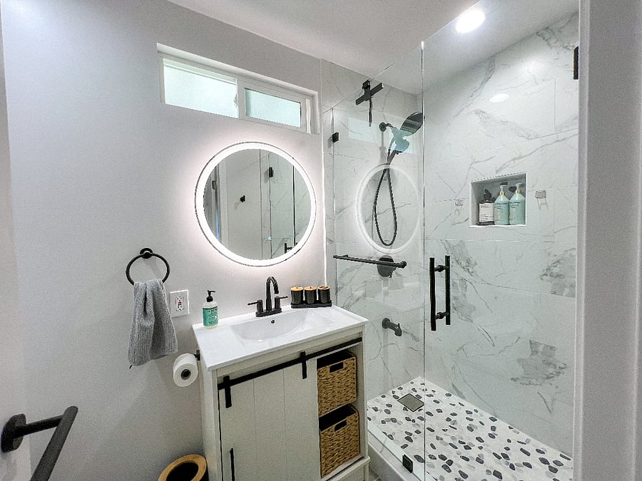 Main Guest Suite Bath with shower, anti-fog LED vanity, toilet, bidet, washcloths, hairdryer and basic bathroom essentials.