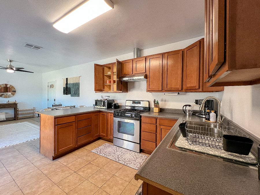 Guest full kitchen with toaster, microwave, coffee maker, tea kettle, rice cooker, electric griddle, pots, pans, flatware and basic pantry items and spices.