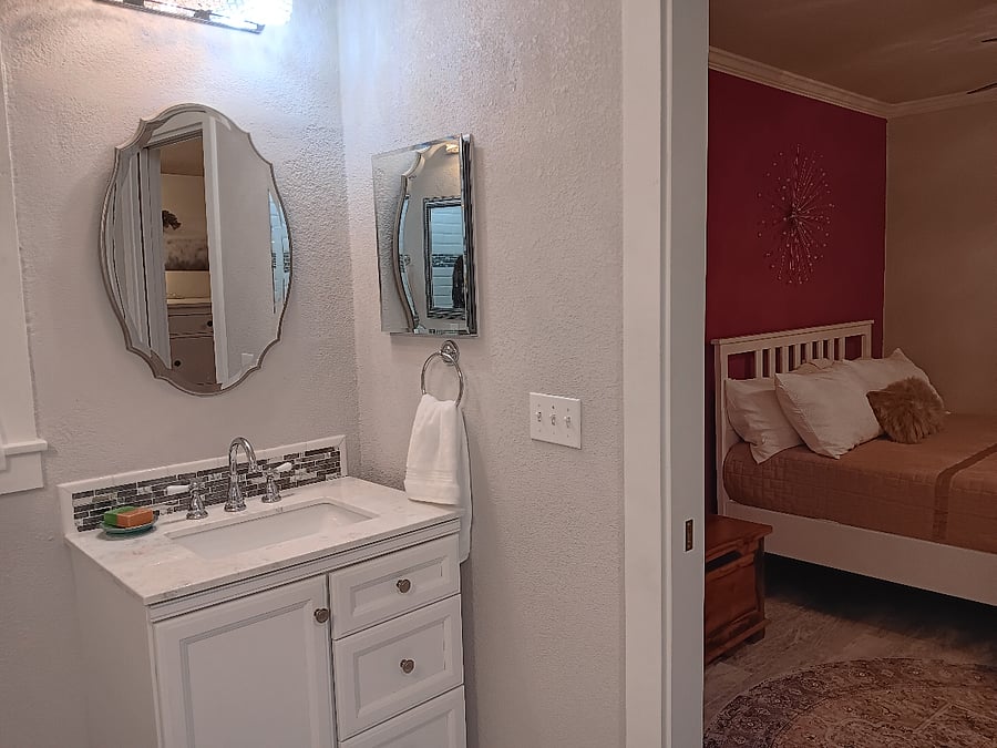 Master bath looking into bedroom with queen bed and 11" mattress