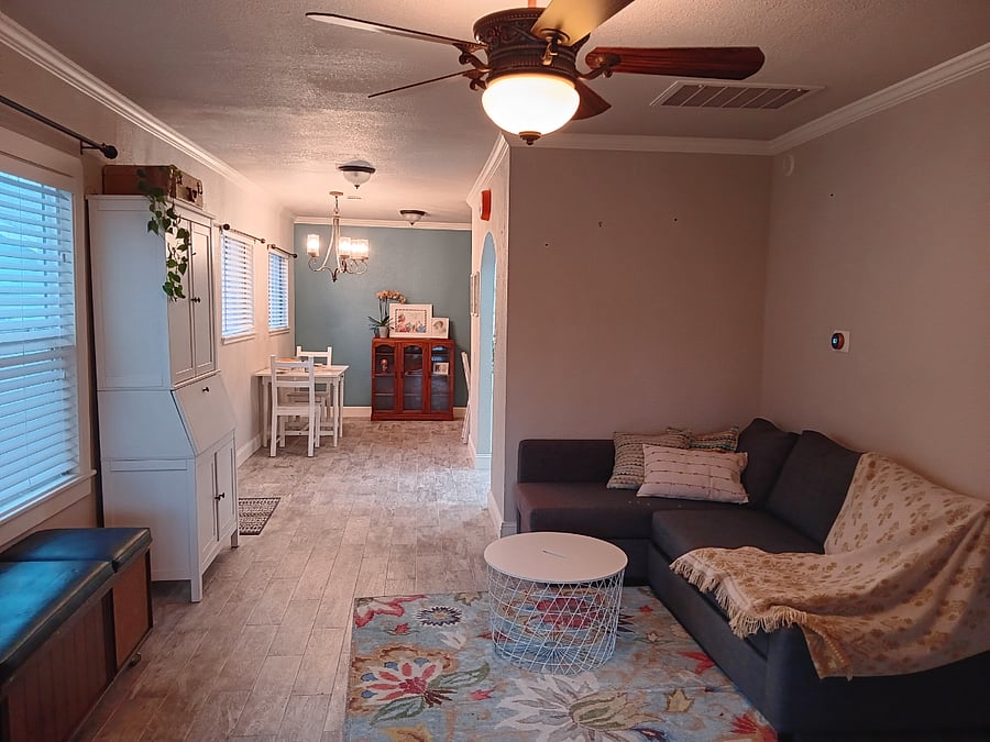 Looking from the front door through the living room into the dining room. Master Suite is directly to the right.