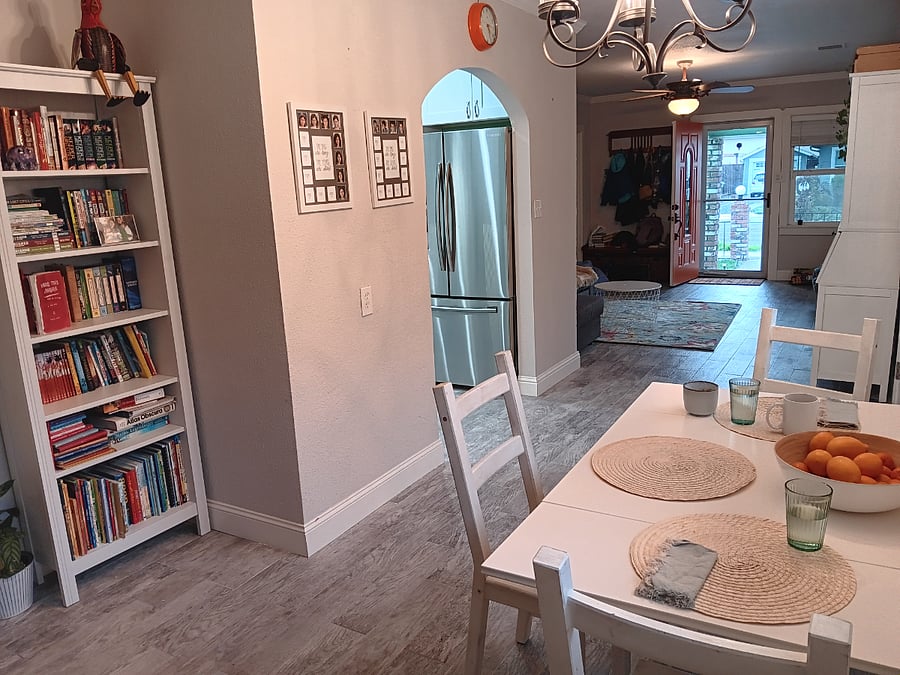 View from dining room looking towards kitchen, living room, and front door.