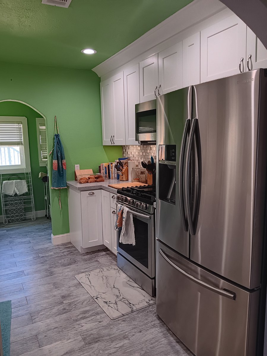 View of the shared kitchen and the laundry room just beyond.