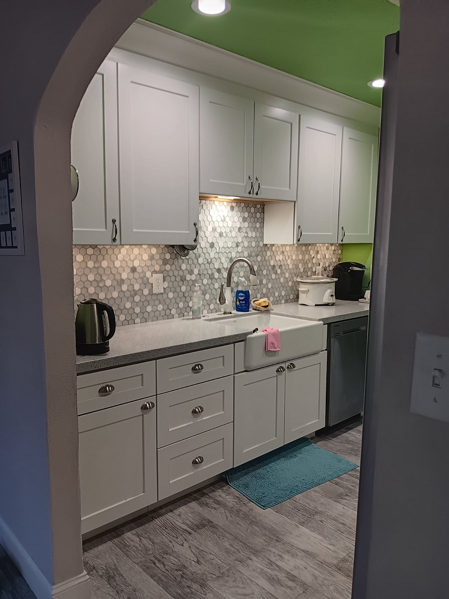 The shared kitchen has a cabinet just for you to store food. You're welcome to use the Keurig too. Just beyond this is the shared laundry room.