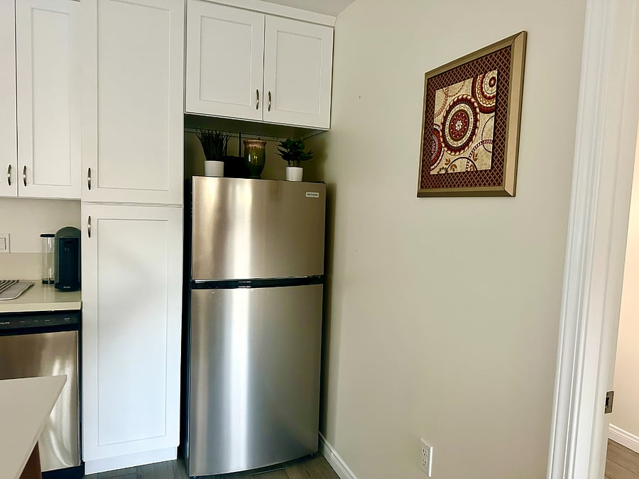 Large cabinets stocked with pots, pans, and a variety of extra supplies. 