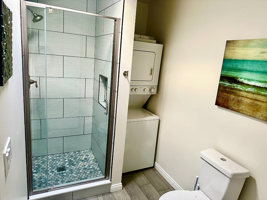 Relaxing shower w/ washer and dryer in unit.