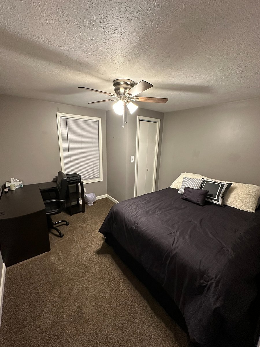 Main-floor bedroom with new ceiling fan. Office desk and chair.