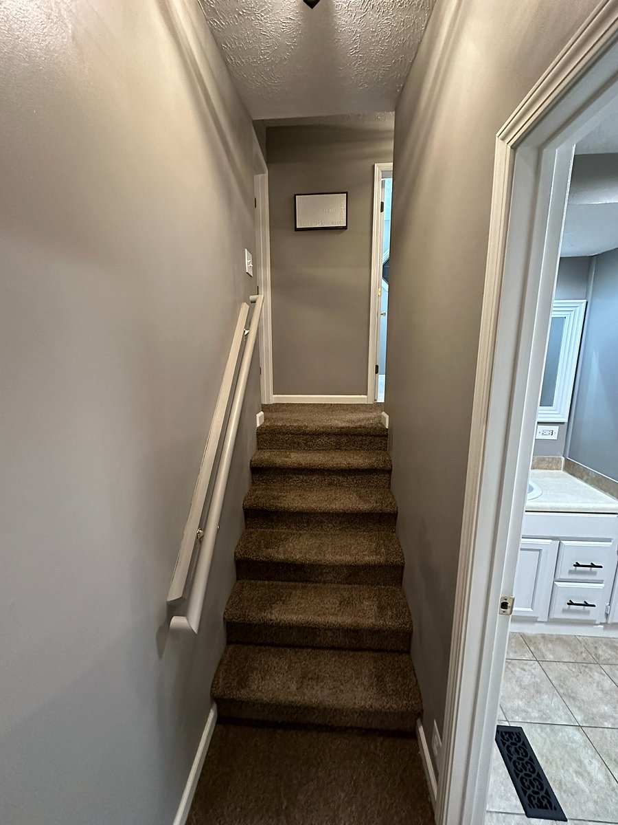 Stairs from main floor to two upstairs bedrooms and bathroom. 