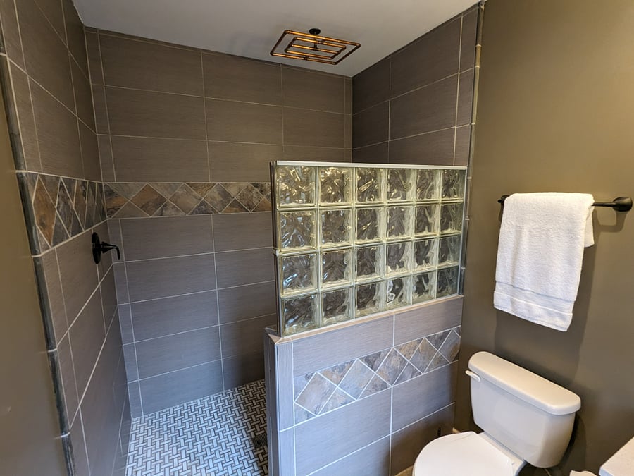 Extra large walk-in shower with a custom made rainfall showerhead for you to relax and unwind.
