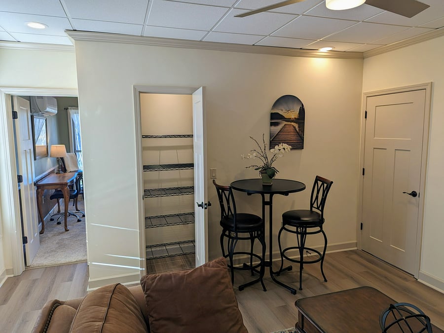 An intimate dining space with a cafe height table and chairs.