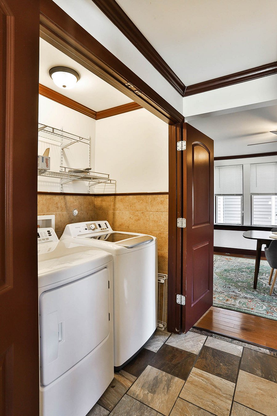 Brand new washer/dryer combo just off the kitchen with storage plus ironing board, iron, drying rack.