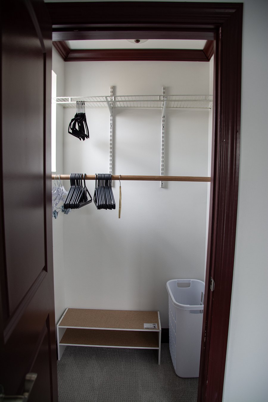 Spacious closet with laundry/dry cleaning bin, shoe storage.