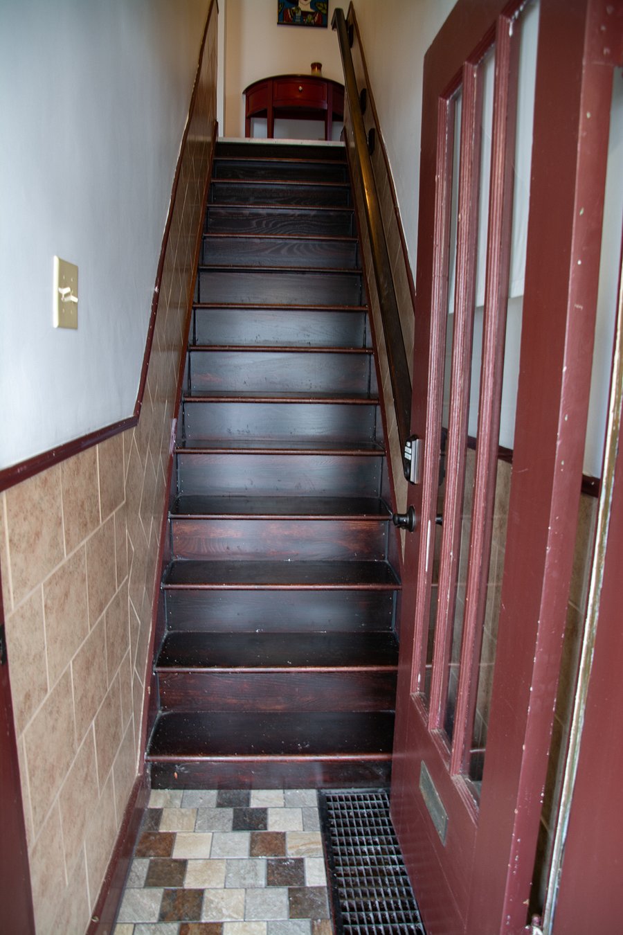 Separate front porch entrance to stairwell. Back entrance shares porch with other tenant, but stairs up have private door with lock.