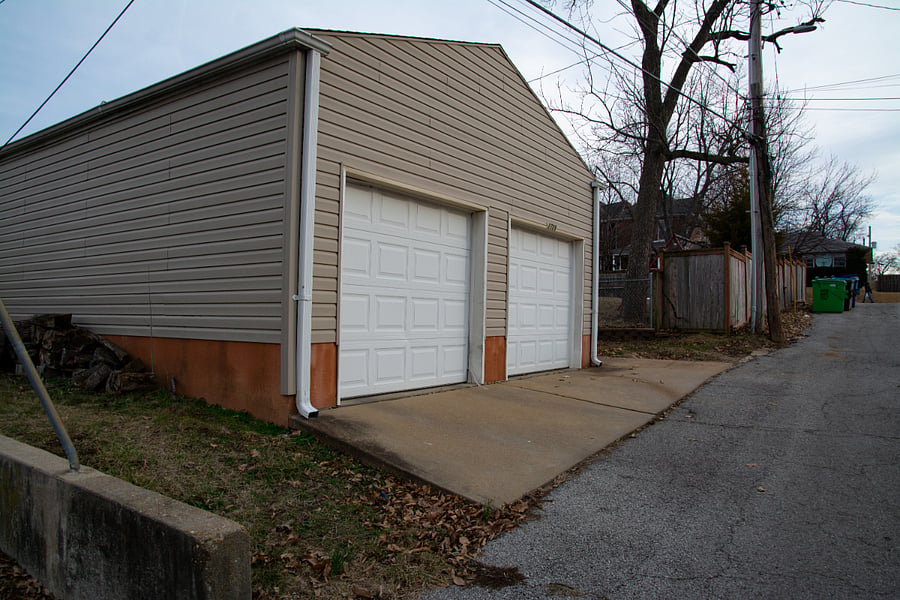 Garage in back of house with alley access. Garage door opener and man door to back yard, back entrance of house.