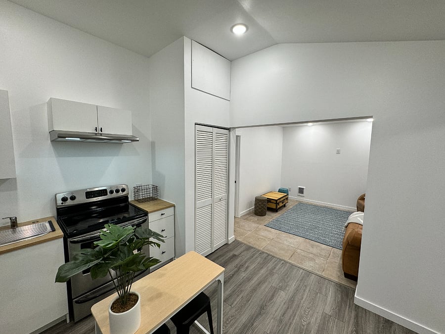 View from kitchen corner, showcasing the open floor plan transition from kitchen to bedroom