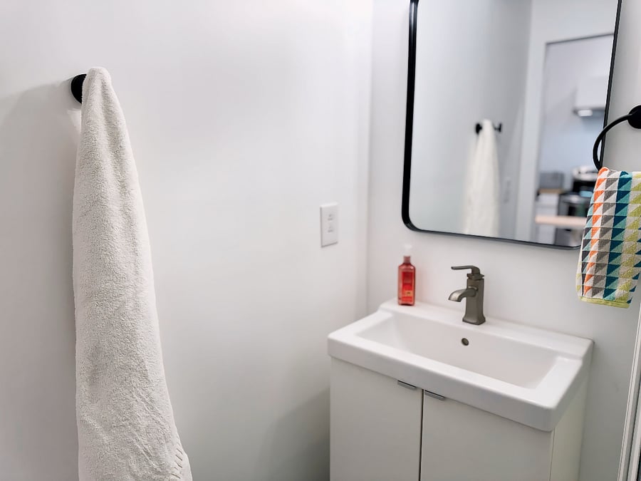 Nice, right-sized vanity w/ storage.  Modern fixturing