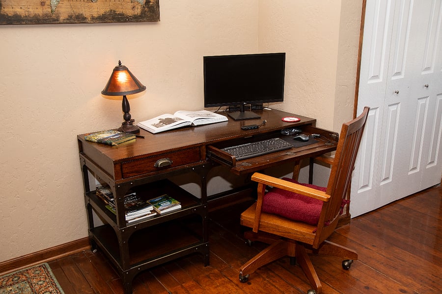 Living Room - standard desk with external monitor available, office chair.