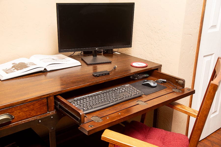 Living Room - standard desk with external monitor available, office chair.