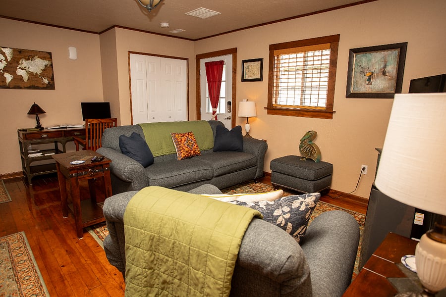 Living Room - comfortable couch, chair and ottoman, standard desk with external monitor available, office chair.