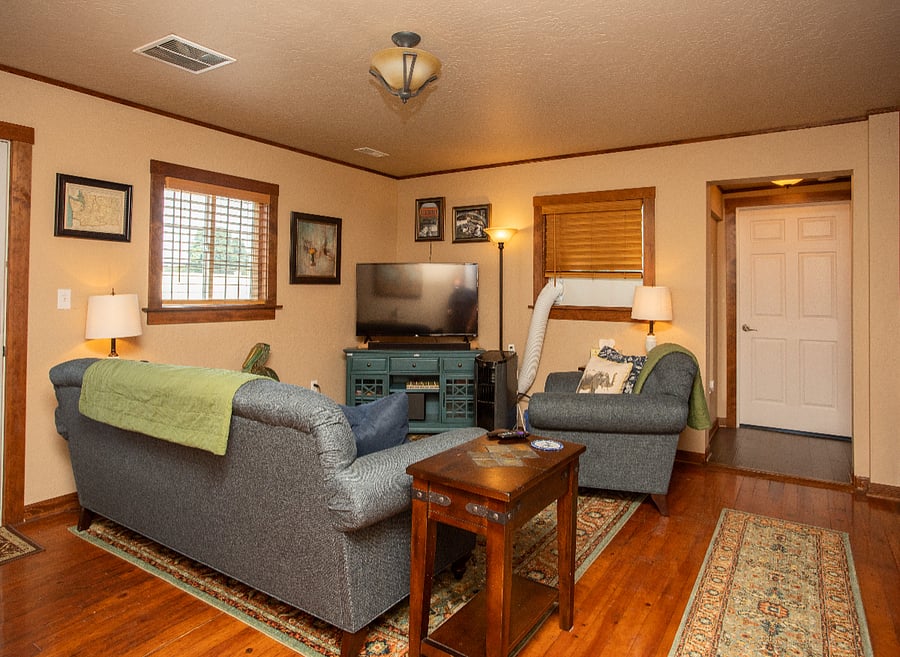 Living Room - comfortable couch, chair and ottoman (air conditioner removed in winter)