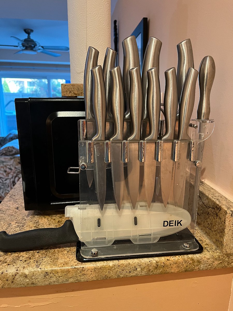 Set of GOOD knives including a high end chef's knife with cutting board.