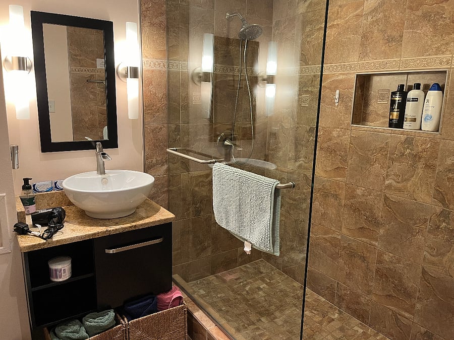 Beautiful high end bathroom! The top to bottom glass is customized where there will never be soap scum spots IF you squeegee each time! Squeegee supplied. Please help keep the glass beautiful!