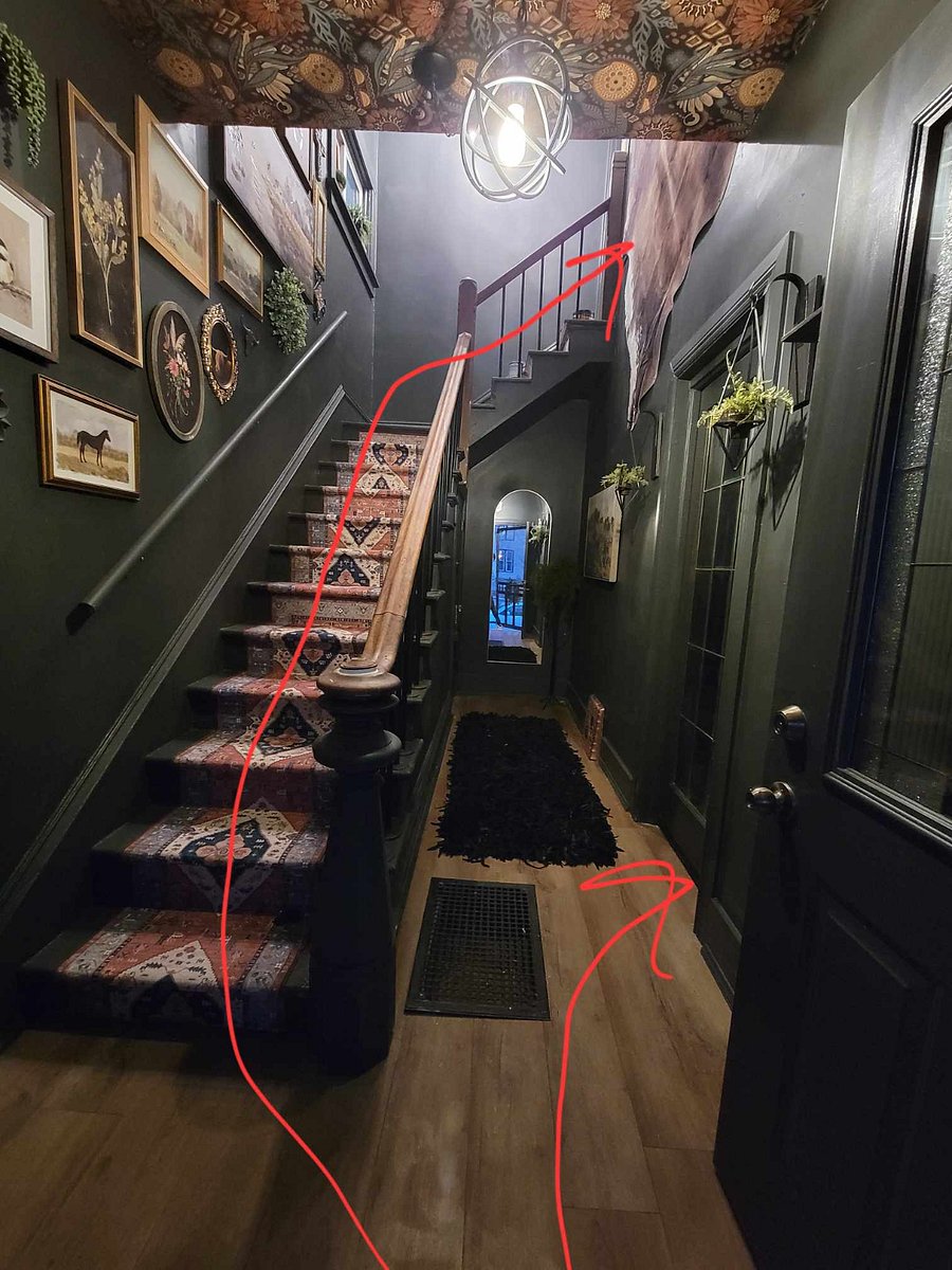 This is the hallway as you enter the property. The stairs lead up to the upper unit, and the door to the right goes to the main level unit. The door to the basement for laundry access is located underneath the stairs.