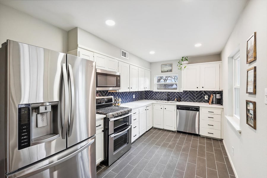 Generous kitchen, which includes a full-size fridge, gas stove/oven, microwave, dishwasher, plenty of cabinet space, and all the dishes/kitchen supplies!