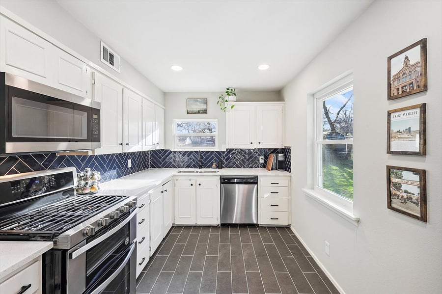 Generous kitchen, which includes a full-size fridge, gas stove/oven, microwave, dishwasher, plenty of cabinet space, and all the dishes/kitchen supplies!