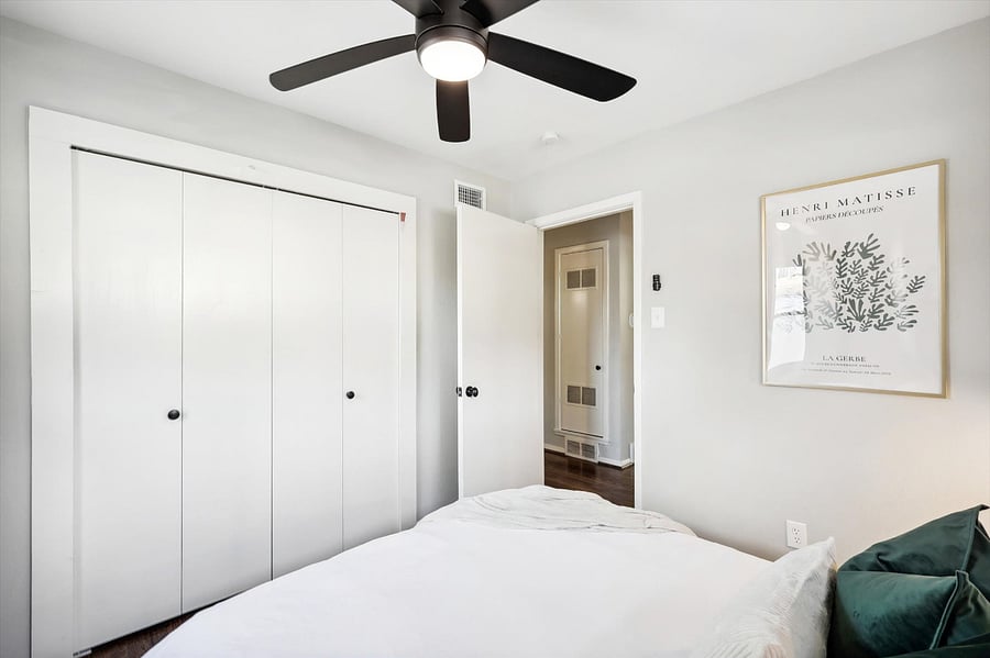 Soothing guest bedroom, complete with a comfy queen-size bed/mattress, blackout curtains, and plenty of storage space in under-bed drawers and closet.