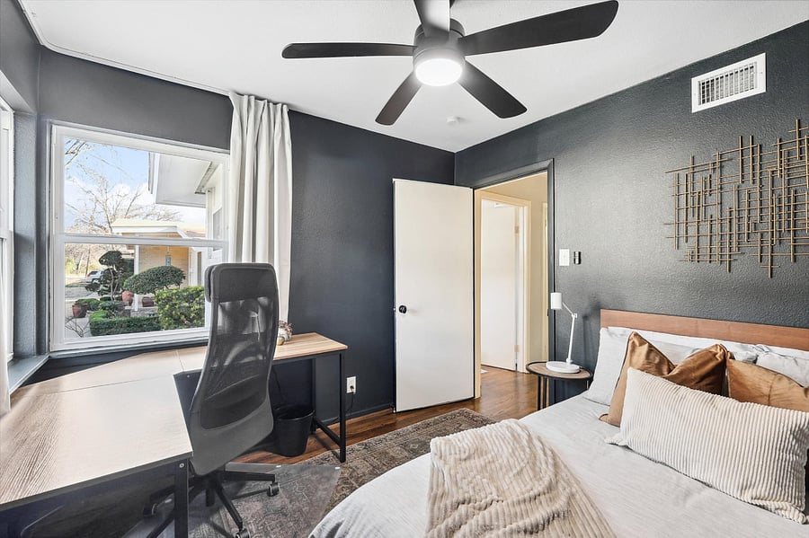 Cozy guest bedroom/office, complete with a comfy full-size bed/mattress, blackout curtains, a closet for storage, and a corner desk with sweeping outdoor views - best seat in the house - perfect set up for computer work - comfy office chair included!
