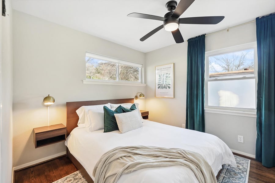 Soothing guest bedroom, complete with a comfy queen-size bed/mattress, blackout curtains, and plenty of storage space in under-bed drawers and closet.