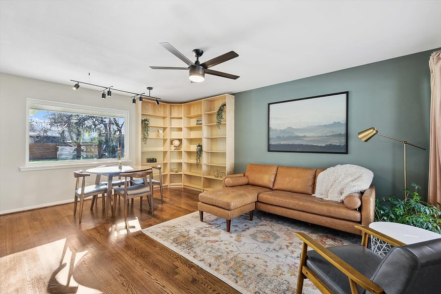 Spacious Living Room, with lots of natural light! Huge picture window, which brings in the outdoor beauty. Full corner bookcase for plenty of storage. Comfy furniture. Soothing and warm colors.