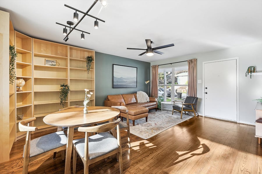 Spacious Living Room, with lots of natural light! Full corner bookcase for plenty of storage. Comfy furniture. Soothing and warm colors.