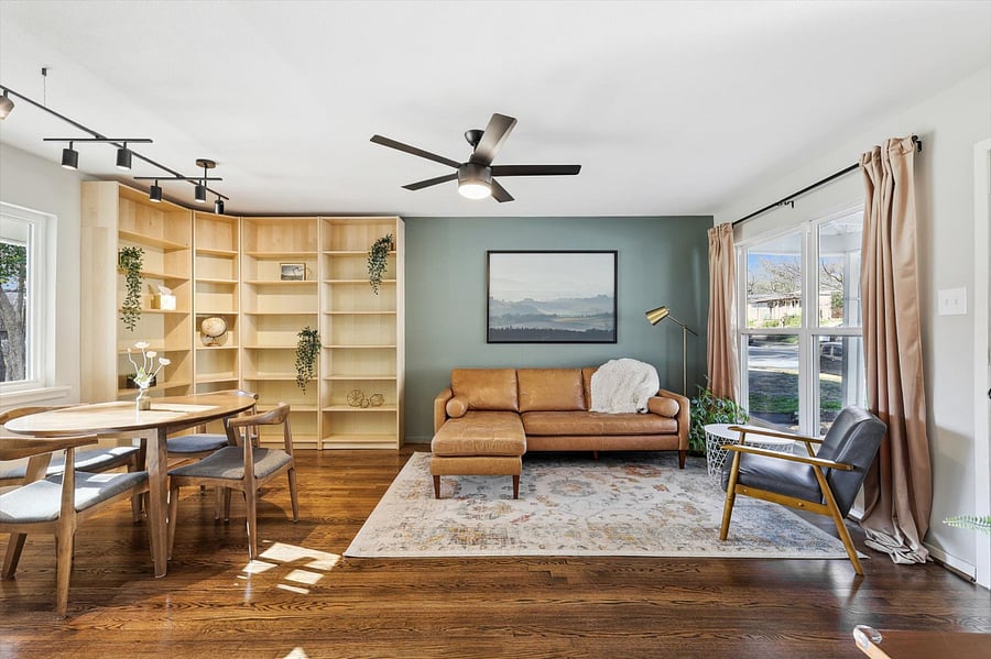 Spacious Living Room, with lots of natural light. Full corner bookcase for plenty of storage. Soothing and warm colors. Comfy furniture.