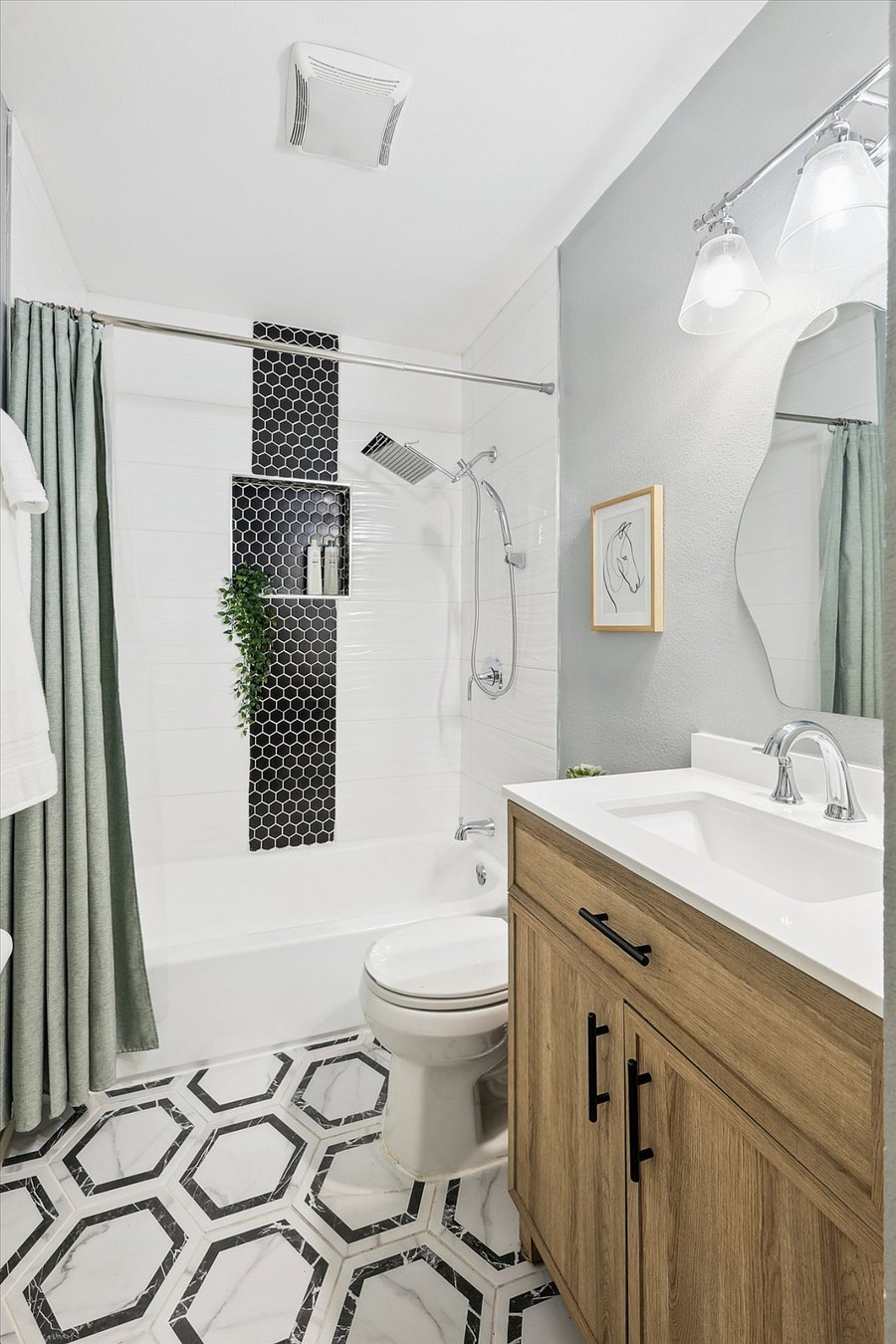 Modern and elegant bathroom, with lots of cabinet space (built into wall) and a brand new rain shower with hand-held attachment.