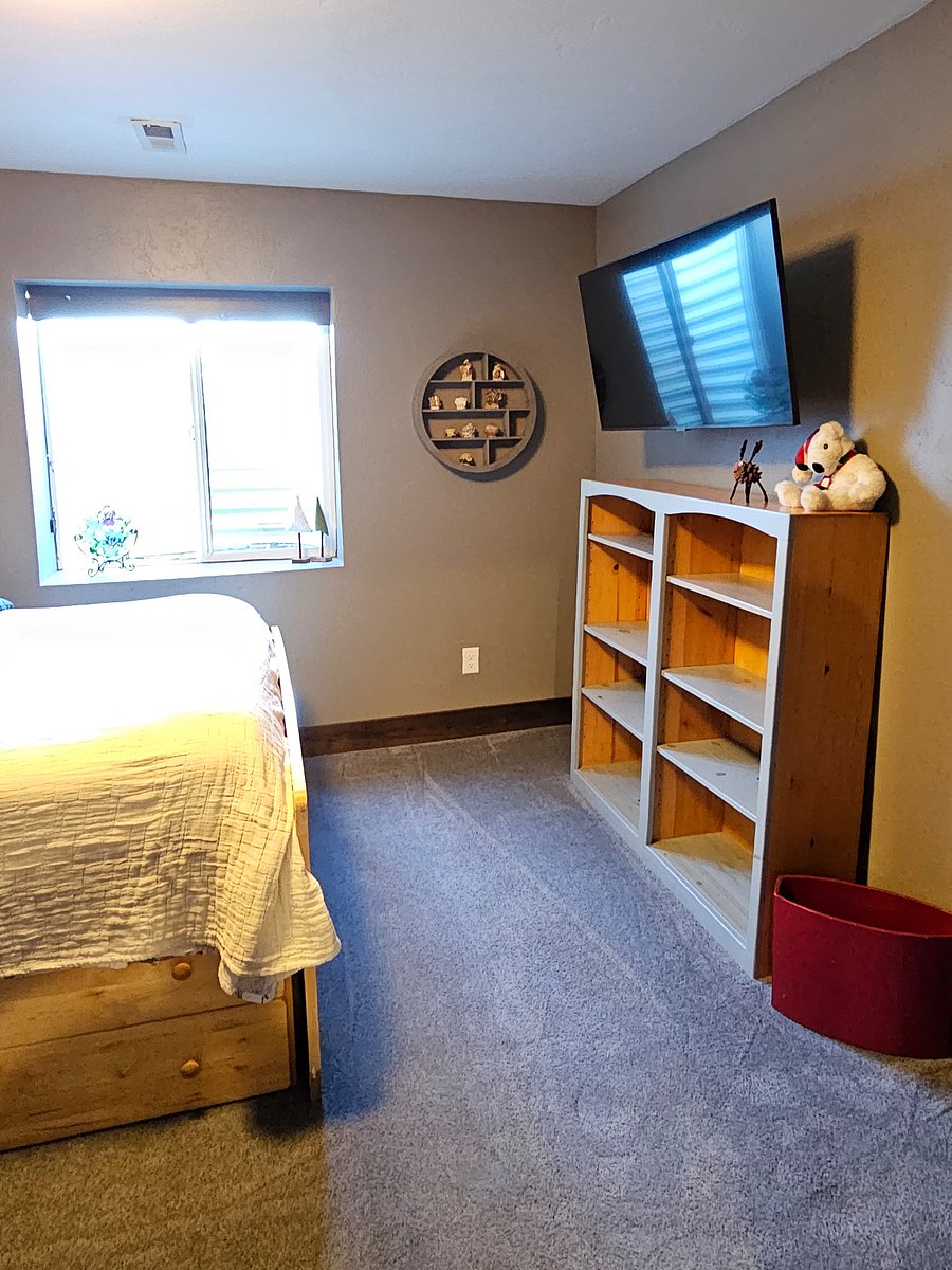 view of bedroom bookcase and private smart TV.