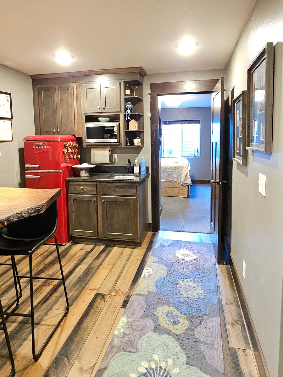 Kitchenette area with refrigerator, microwave and sink with a beautiful bar to sit at if you like.