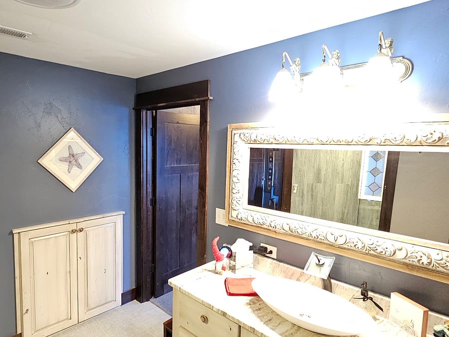View of vanity and linen closet in bathroom. Bathroom is large and spacious.