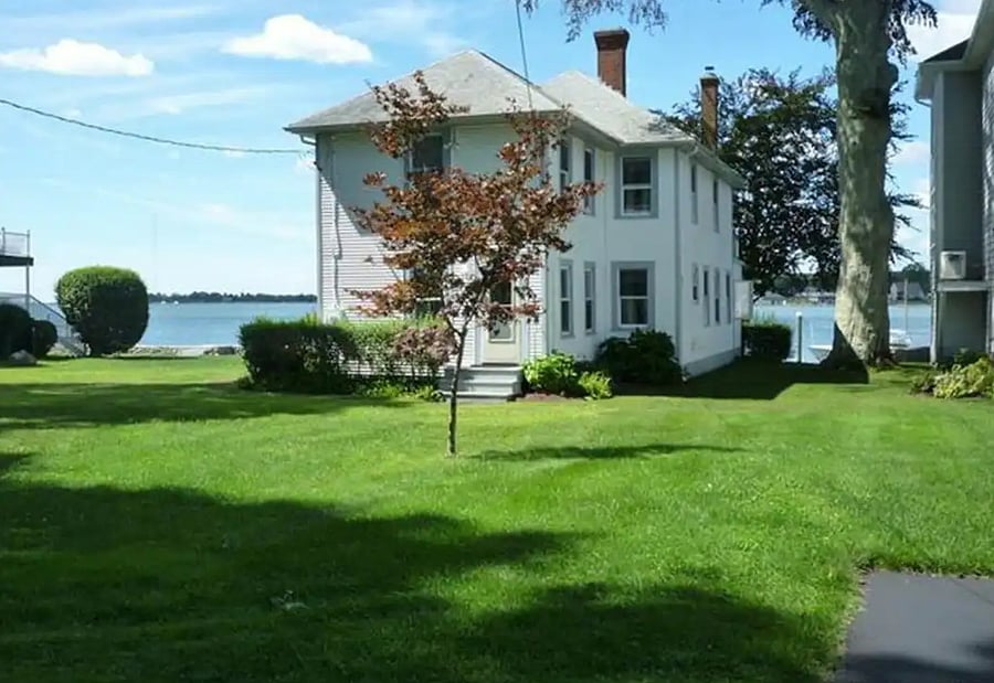 View of the front of cottage facing the water.
