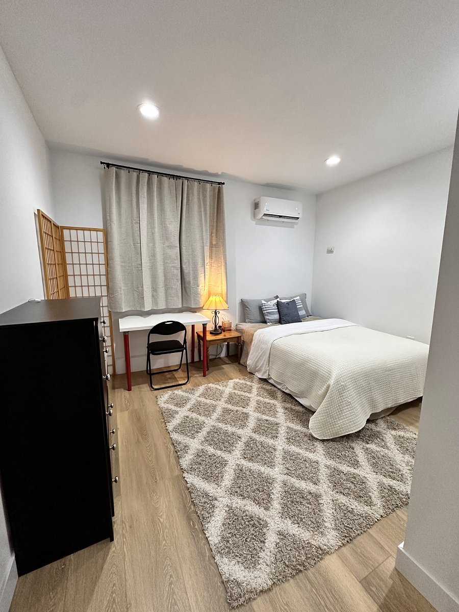 Bedroom with queen sized bed and work desk