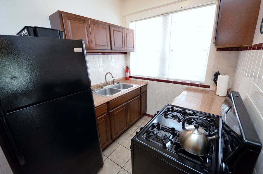 Kitchen With A Full Sized Fridge, Gas Stove, Deep Sink, Microwave & Everything You Would Need To Prepare A Meal 