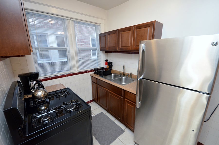 Kitchen With A Full Sized Fridge, Gas Stove, Deep Sink, Microwave & Everything You Would Need To Prepare A Meal 