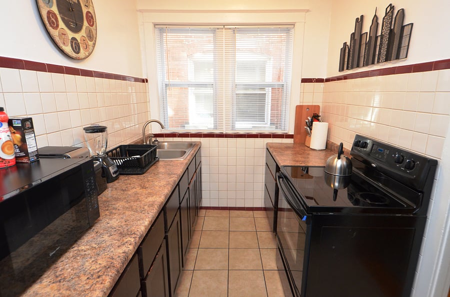 Kitchen With A Full Sized Fridge, Gas Stove, Deep Sink, Microwave & Everything You Would Need To Prepare A Meal 