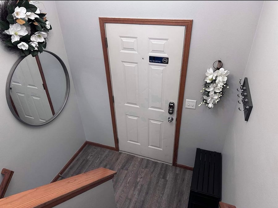 entry way with coat rack, shoe rack, mirror