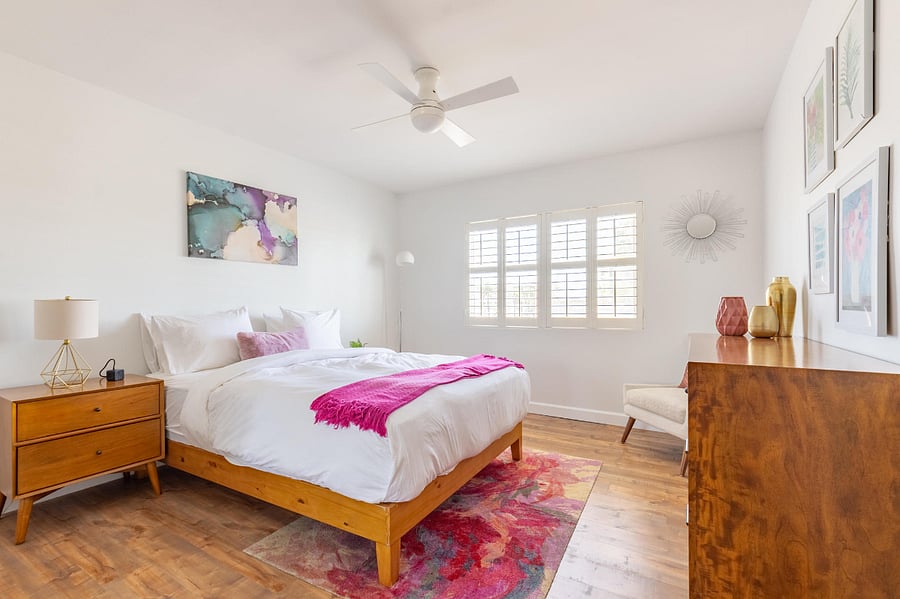 Large bedroom with comfy queen-sized bed and plantation shutters. 